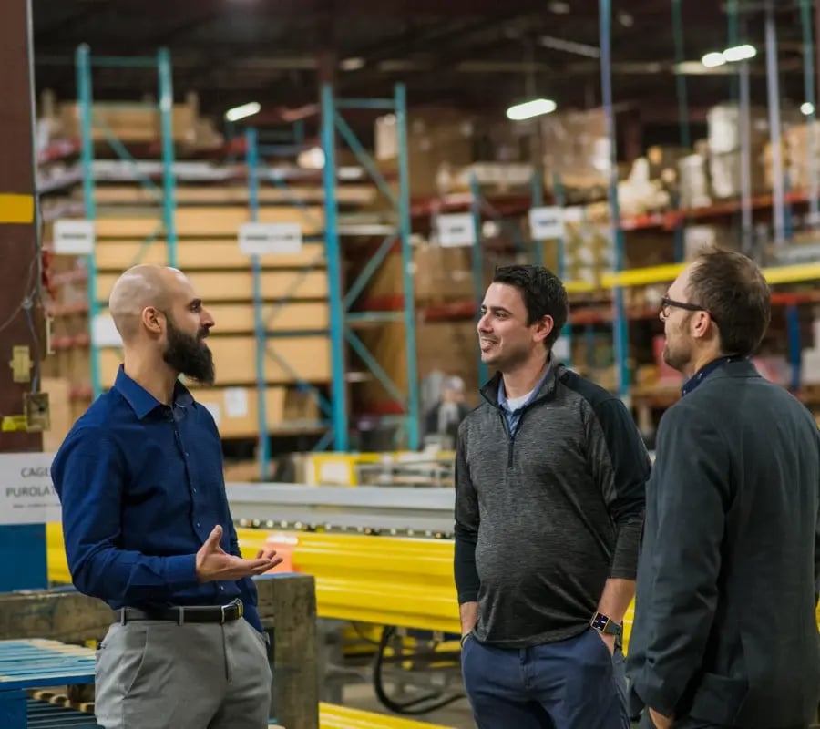 Toyota automated logistics careers in warehouse automation - employees talking to customer in warehouse
