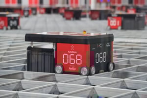 AutoStore robot number 068 navigating an automated warehouse storage grid system.