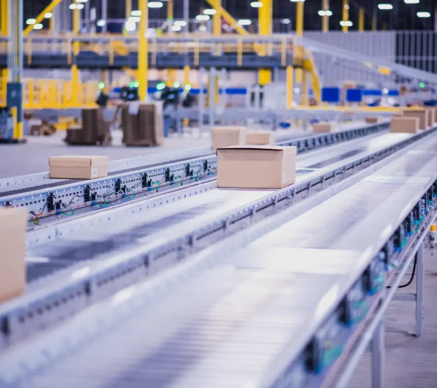 Automated conveyor system transporting packages through a modern 3PL warehouse facility.