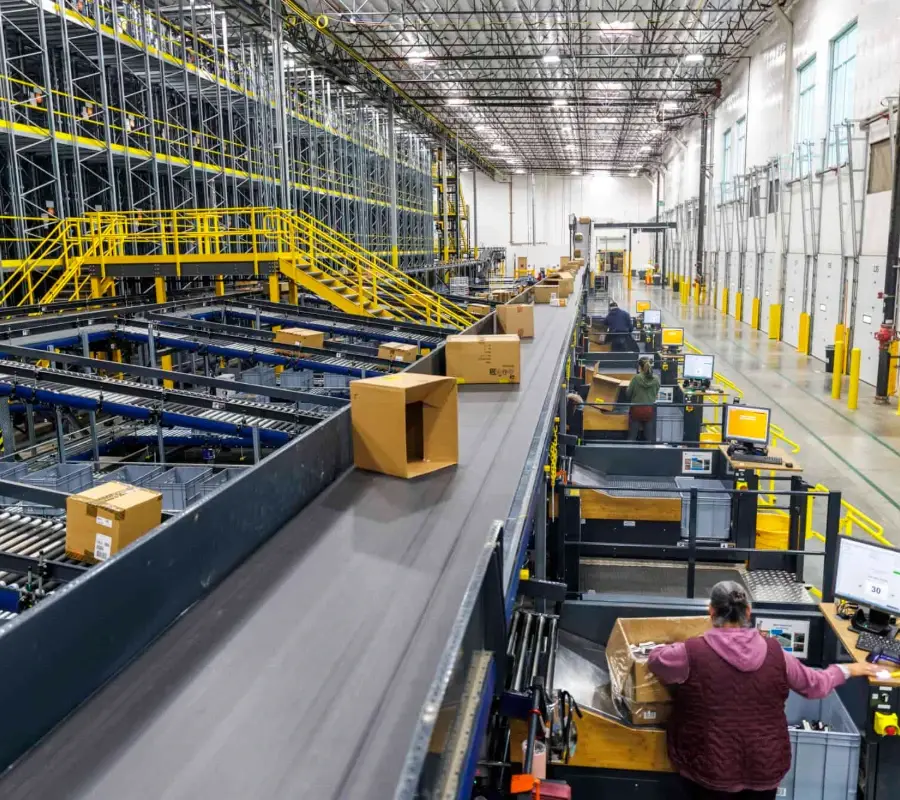 Workers in a large general merchandise distribution warehouse.