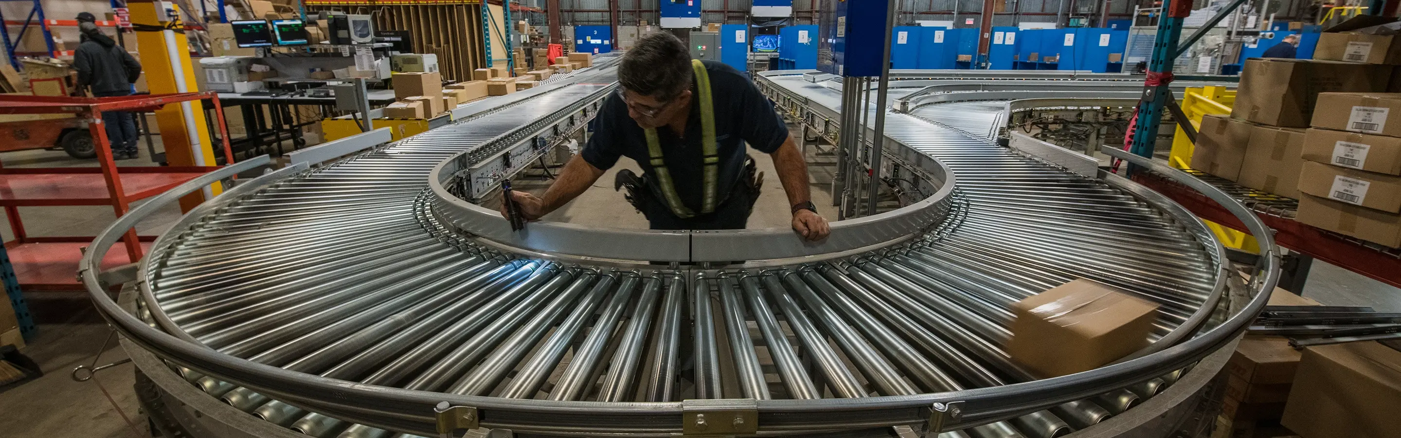 warehouse automation support technician inspecting conveyor