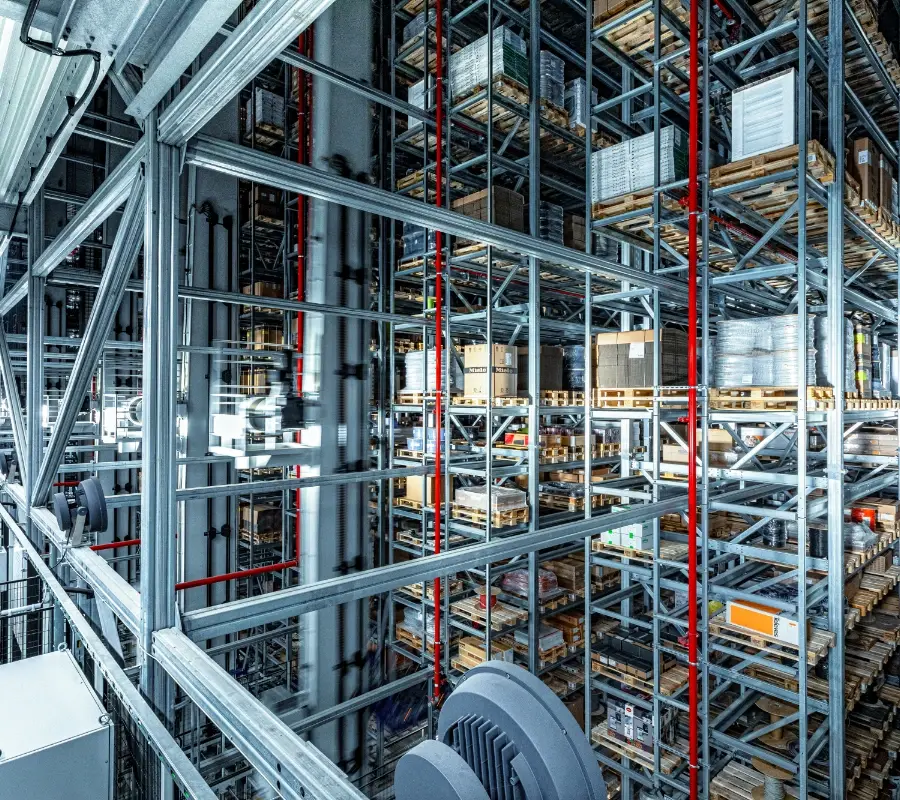 High-density automated storage and retrieval system (ASRS) with metal racking in a modern warehouse.