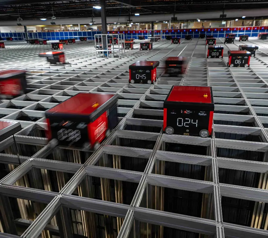 AutoStore robots moving on a storage grid in an automated goods-to-person warehouse.
