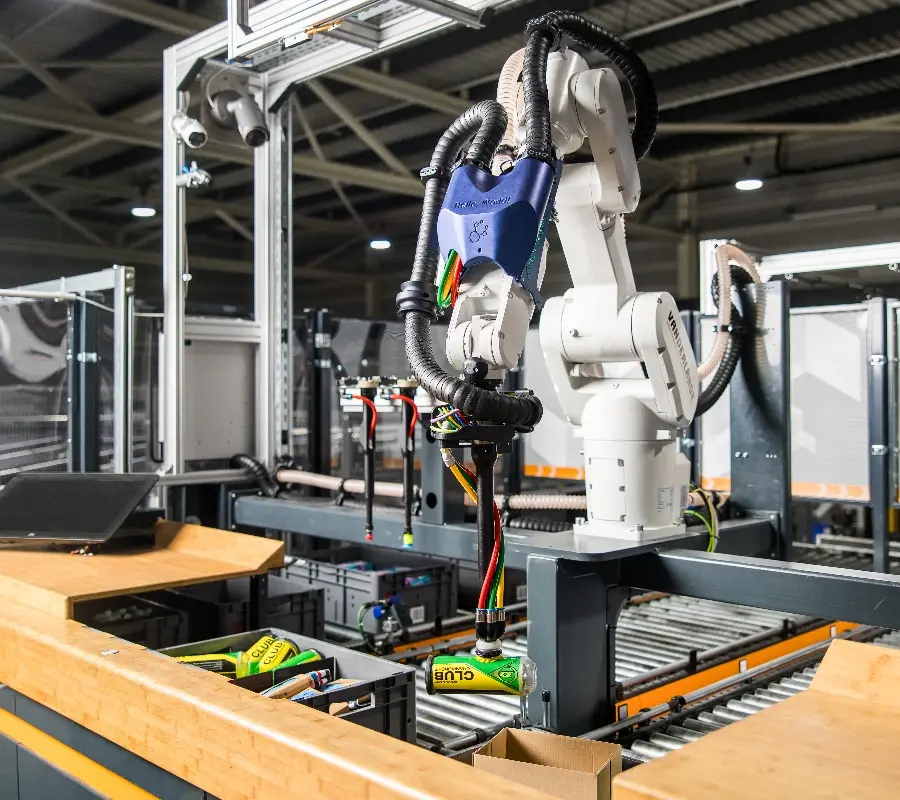 White industrial robot perform automated piece picking.