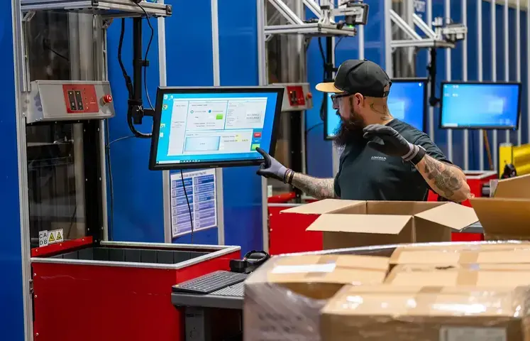 warehouse worker at goods to person workstation